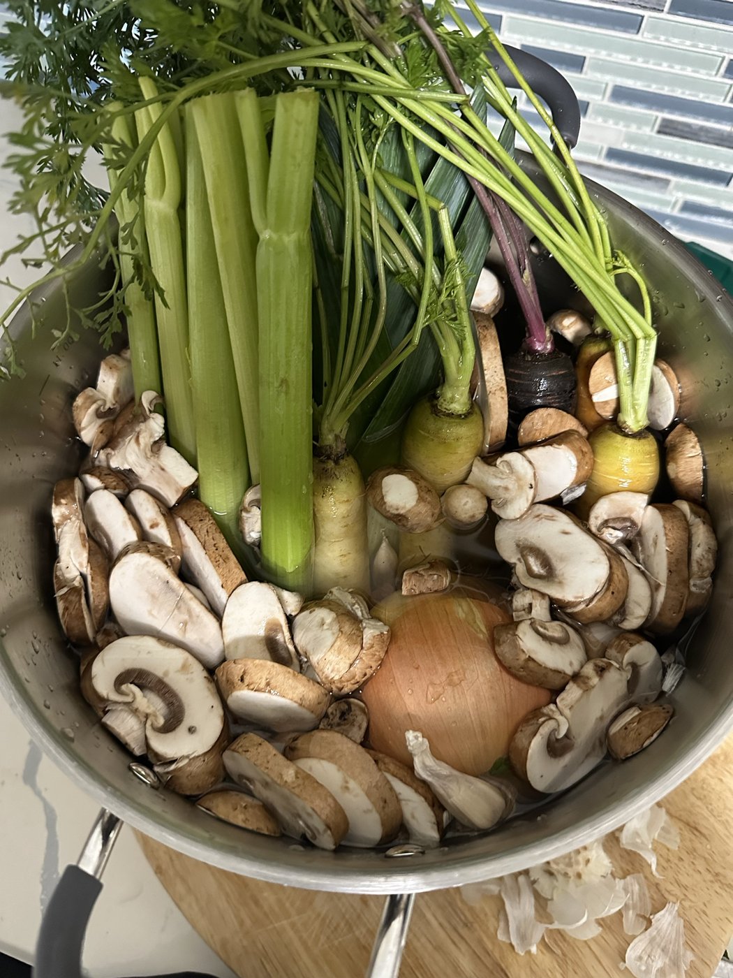 Stockpot filled with carrots, celery, leek, onion and mushrooms